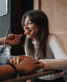 girl smiling while eating at restaurant