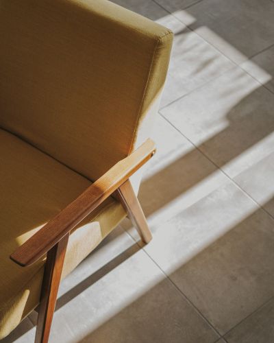 Modern yellow chair and sunlight on the floor